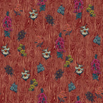 Detail of wallpaper in a varied floral print on a wood-grain field in shades of red, pink, yellow and green.