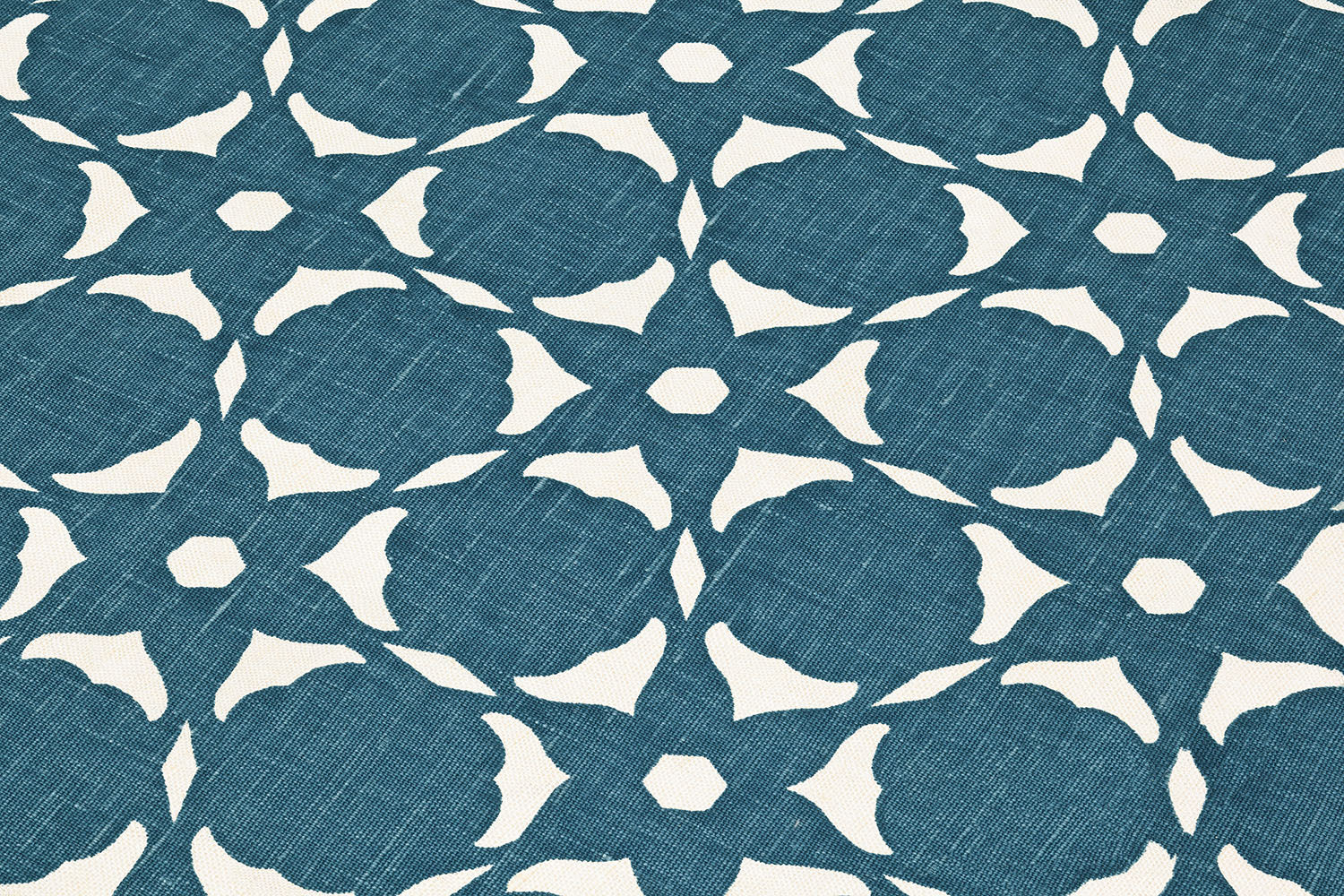 Fabric yardage in a floral lattice print in cream on a navy field.