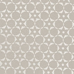 Fabric in a floral lattice print in white on a greige field.