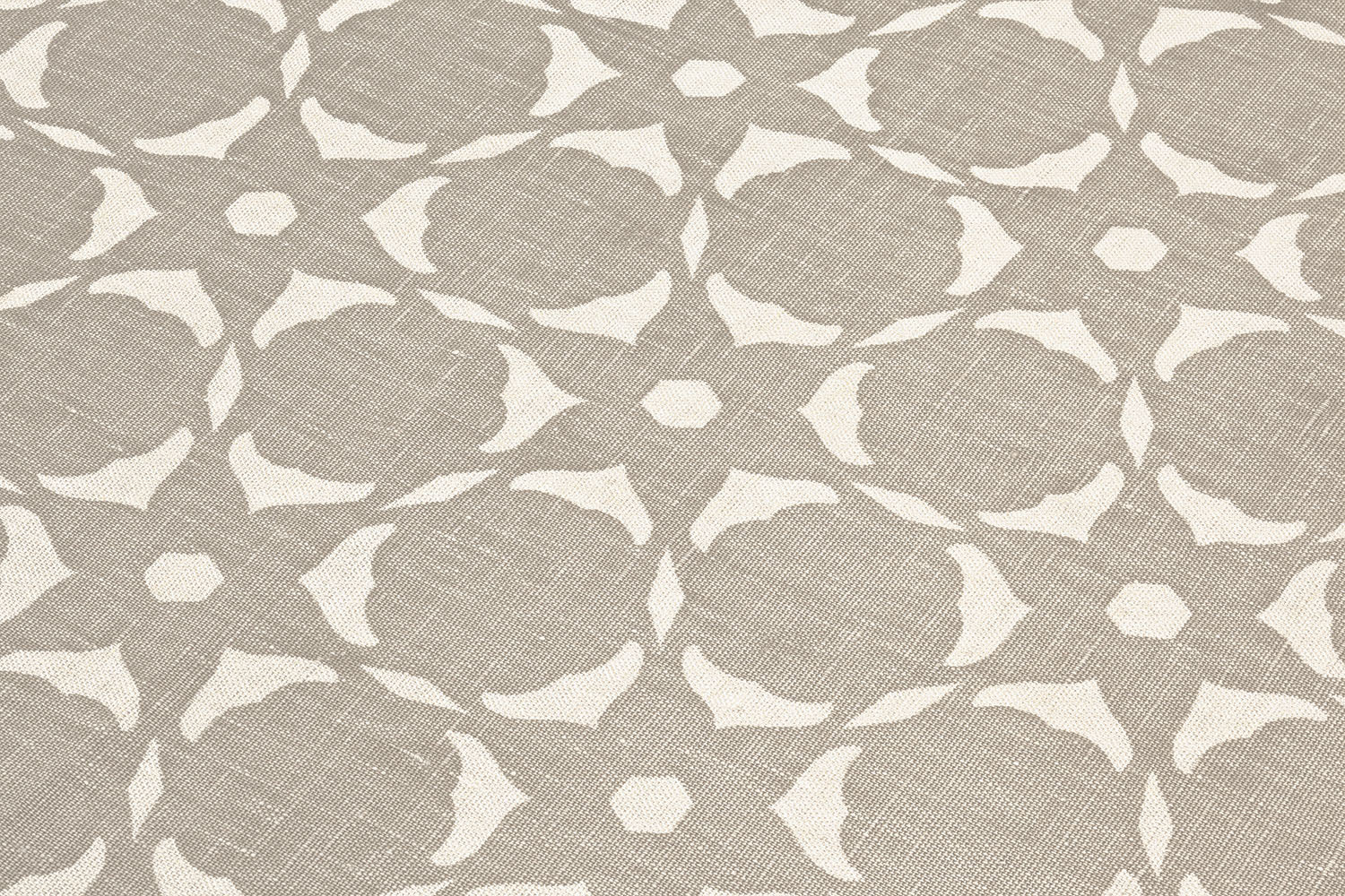 Fabric yardage in a floral lattice print in white on a greige field.