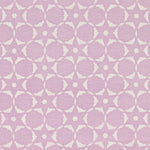 Fabric in a floral lattice print in cream on a light purple field.