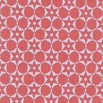 Fabric in a floral lattice print in light blue on a coral field.