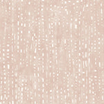 Detail of wallpaper in a painterly small-scale dashed dot print in white on a pastel pink watercolor field.
