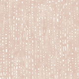 Detail of wallpaper in a painterly small-scale dashed dot print in white on a pastel pink watercolor field.