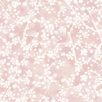 Detail of wallpaper in a painterly branch print in white on a pink watercolor field.