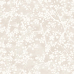Detail of wallpaper in a painterly branch print in white on a soft beige watercolor field.