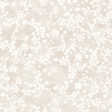 Detail of wallpaper in a painterly branch print in white on a soft beige watercolor field.