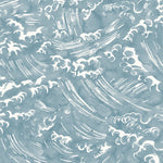 Detail of wallpaper in a playful wave print in white on a chambray blue watercolor field.