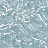 Detail of wallpaper in a playful wave print in white on a chambray blue watercolor field.