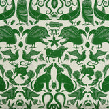 Patterned fabric with animals and sea creatures in green on a white background