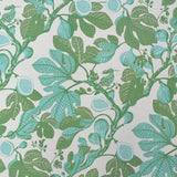 Patterned fabric with green and blue leaves and fruits on a light background