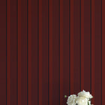 Vase with white flowers against a red striped background