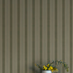 Striped wallpaper with a vase of flowers on a white surface