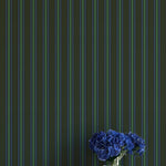 Striped wallpaper with a vase of blue flowers on a white surface