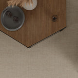 Overhead image of a angled wood coffee table over a beige broadloom carpet. 