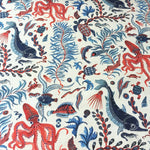 Ocean-themed fabric pattern with red, blue, and black sea creatures on a white background.