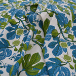 Fabric with blue and green leaf pattern on a white background