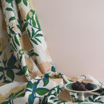 Floral-patterned fabric with figs on a neutral background