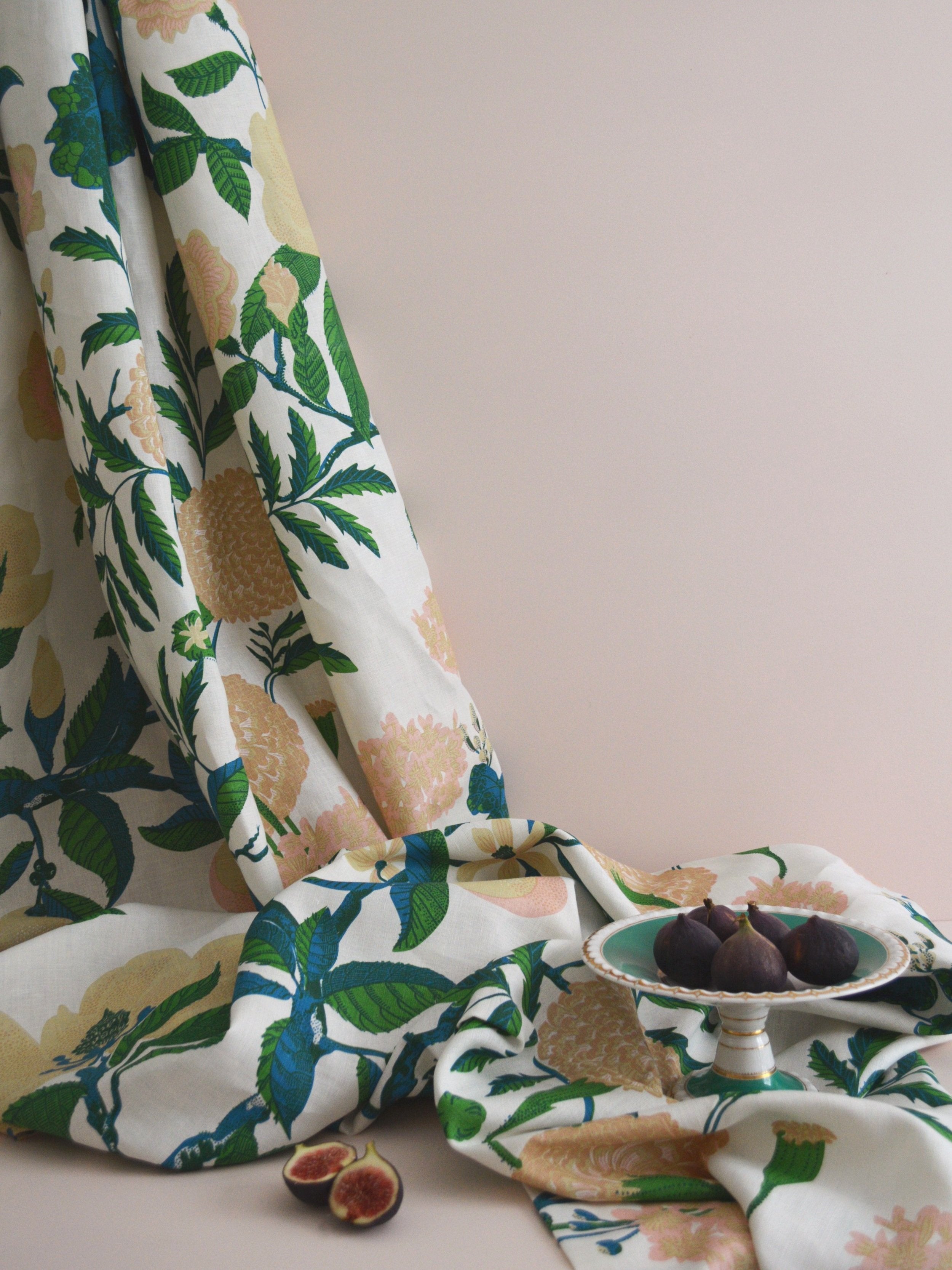 Floral-patterned fabric with figs on a neutral background
