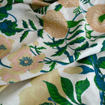 Floral fabric with green leaves and pink flowers on a white background