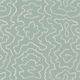 Detail of wallpaper in a minimalist wood grain print in cream on a light turquoise field.
