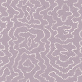 Detail of wallpaper in a minimalist wood grain print in white on a purple field.