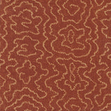 Detail of fabric in a minimalist wood grain print in tan on a rust field.