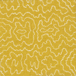 Detail of fabric in a minimalist wood grain print in white on a mustard field.