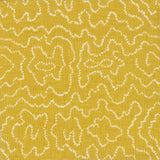 Detail of fabric in a minimalist wood grain print in white on a mustard field.