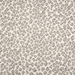 A close-up of a leopard print broadloom in grey and beige spots on a cream background.