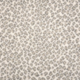 A close-up of a leopard print broadloom in grey and beige spots on a cream background.
