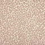 A close-up of a leopard print broadloom in beige and taupe spots on a cream background.