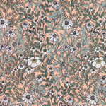 Detail of fabric in a dense floral print in white, tan and green on a light pink field.