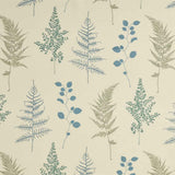 Detail of fabric in a repeating leaf print in blue, green and tan on a cream field.