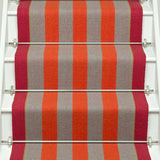 Striped flatweave runner in orange and red and white staircase