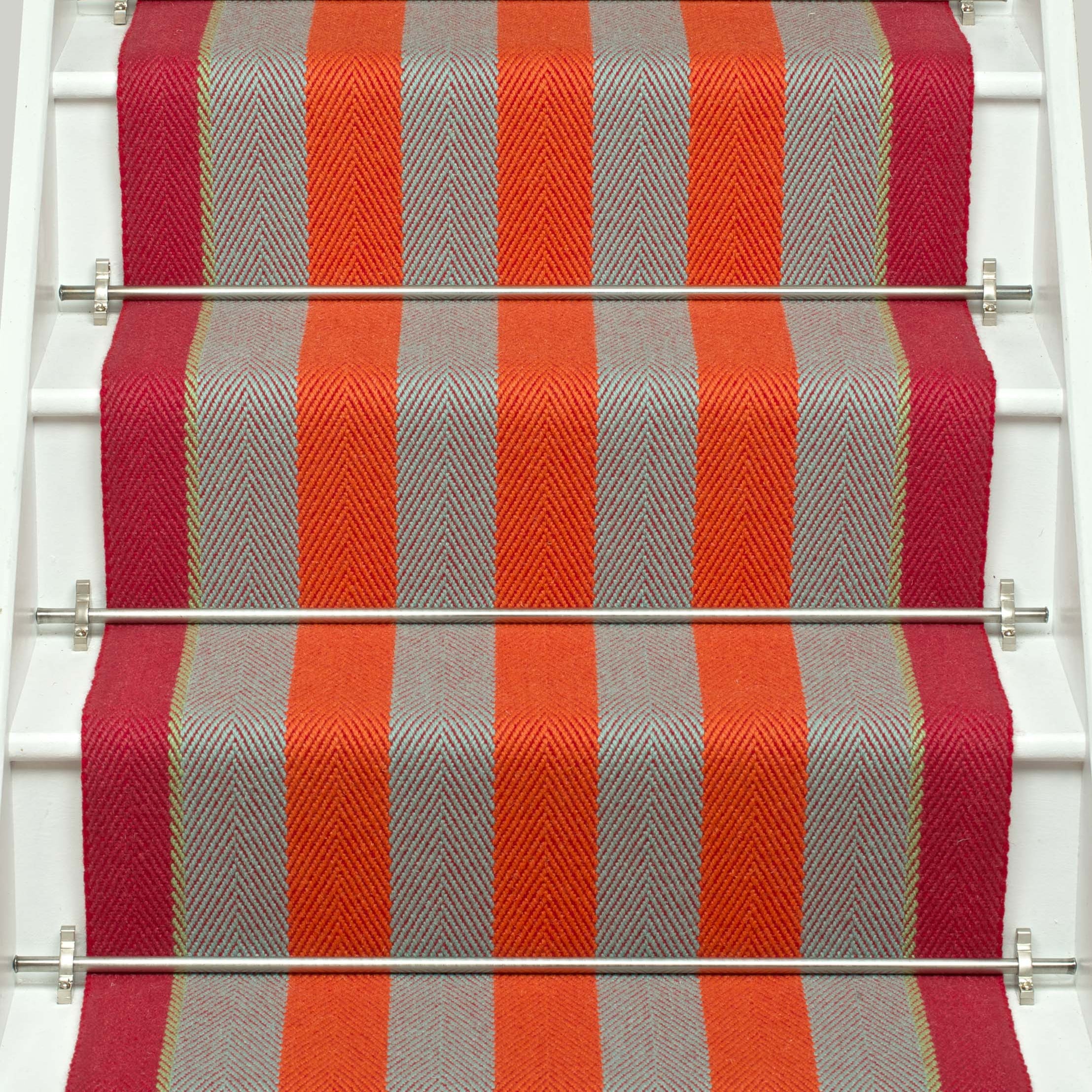 Striped flatweave runner in orange and red and white staircase
