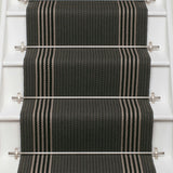 Striped flatweave runner in dark grey and white and black on white staircase