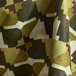 Draped fabric in a bold abstract checkerboard pattern in brown, cream, sage and olive green.