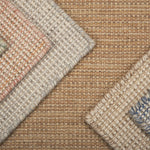 Close-up of various textured rugs with different patterns and colors.