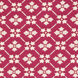 Detail of fabric in a repeating floral lattice print in white and coral on a magenta field.