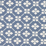 Detail of fabric in a repeating floral lattice print in cream on a blue field.