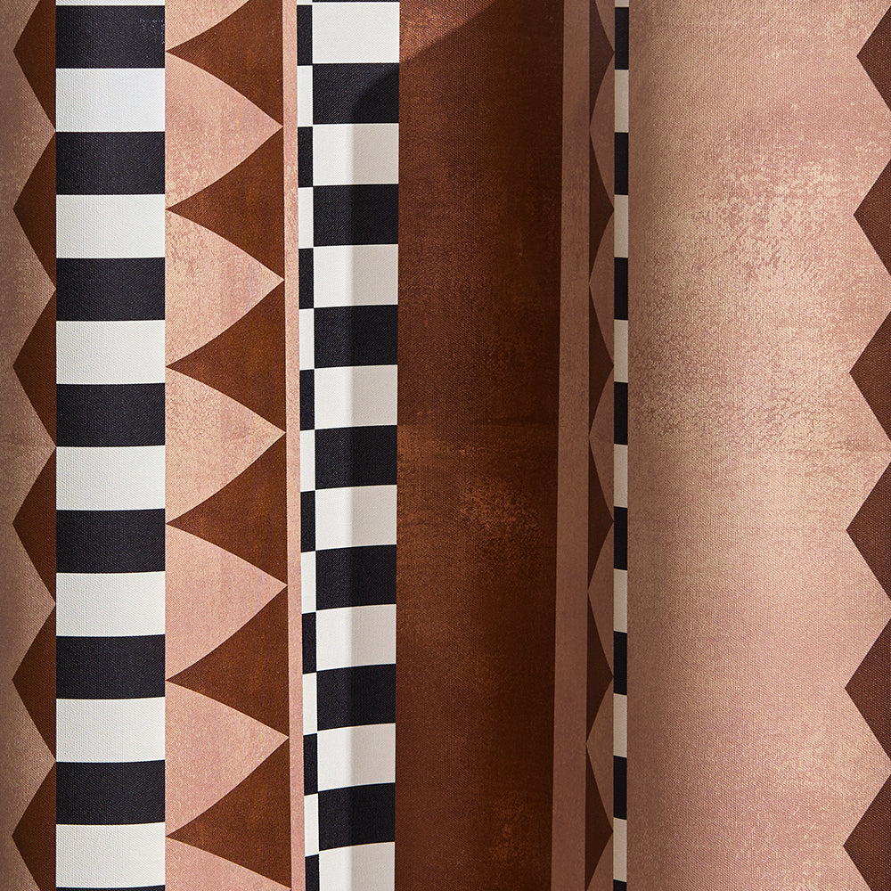Wallpaper detail in bold geometric printed fabric in brown and tan with black and white accents.