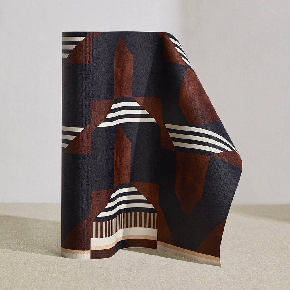 Wallpaper roll in a graphic geometric design in burn siena, black, taupe and cream.