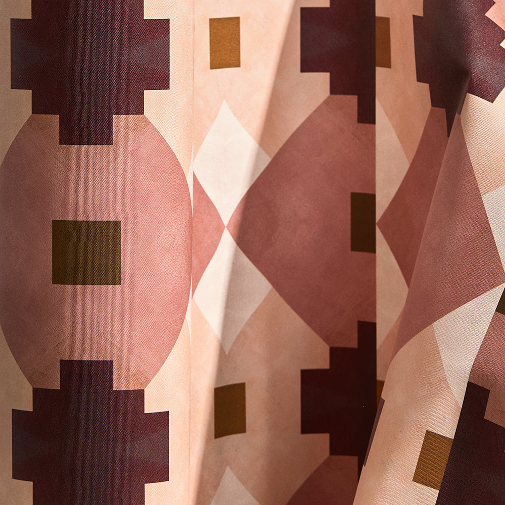 Wallpaper in a bold abstract checkerboard pattern in blush, oxblood, camel and cream.