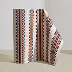 Wallpaper roll in a complex geometric stripe in maroon, ochre, ecru and black on a cream field.
