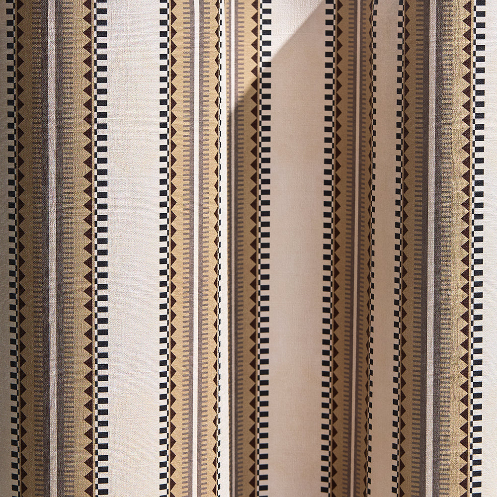 Wallpaper in a complex geometric stripe in brown, tan, taupe and black on a cream field.