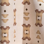 Wallpaper in a geometric stair step pattern in brown and tan on a cream field.