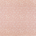 Detail of fabric in a dense petal print in shades of peach on a white field.