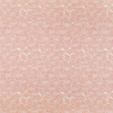 Detail of fabric in a dense petal print in shades of peach on a white field.