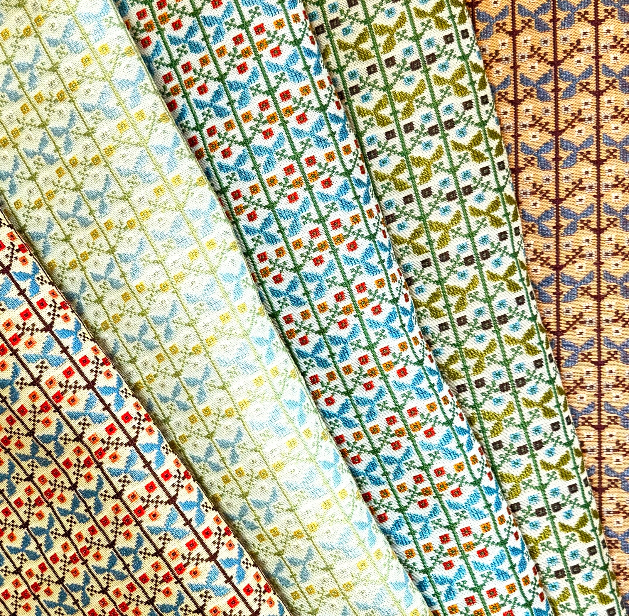 Collection woven floral fabrics in a range of colors.
